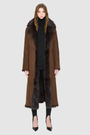 The MAEVE Coat is a heritage-inspired reversible outerwear piece crafted in havanna suede and Toscana rasado teddy. Designed to flip seamlessly from plush wool-out to sleek suede skin-out, it offers versatile styling for both everyday wear and après-ski sophistication. A drop shoulder provides ease of movement, while the fit adapts—regular when worn wool-out and semi-fitted when worn skin-out. An oversized Toscana wool notch collar, slash pockets on the teddy side, and single welt pockets on the suede side 