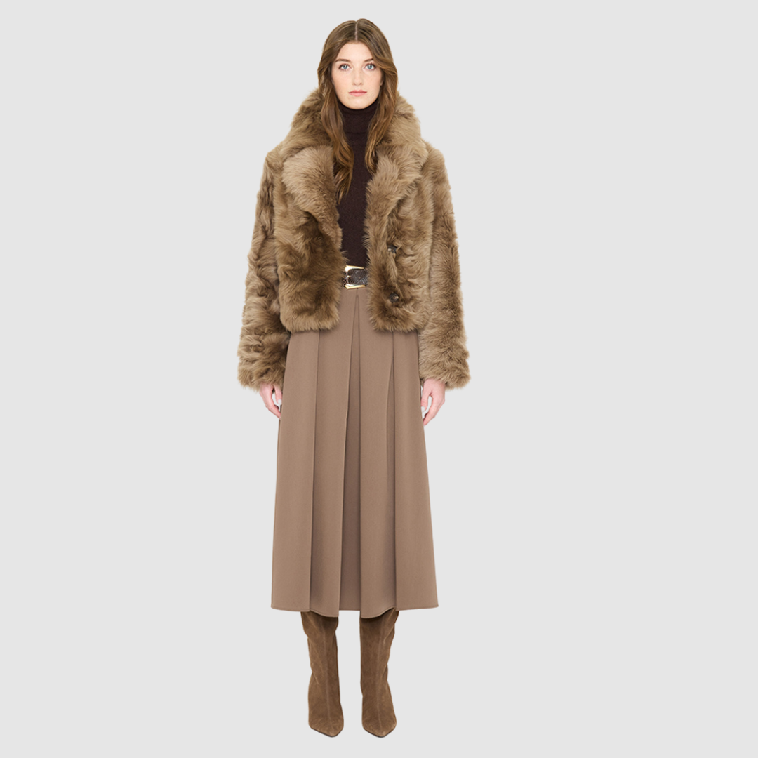 The NIKKI Bomber Jacket is a modern cropped silhouette crafted in luxurious toscana wool. Designed with a drop shoulder and a relaxed fit through the shoulders, arms, and body, it delivers effortless volume and an easy, natural drape. An oversized toscana notch collar and single-breasted button closure give it a clean, minimalist finish, while slash side pockets add everyday functionality. Fully lined for comfort, NIKKI is the ultimate statement jacket for sophisticated cold-weather layering.