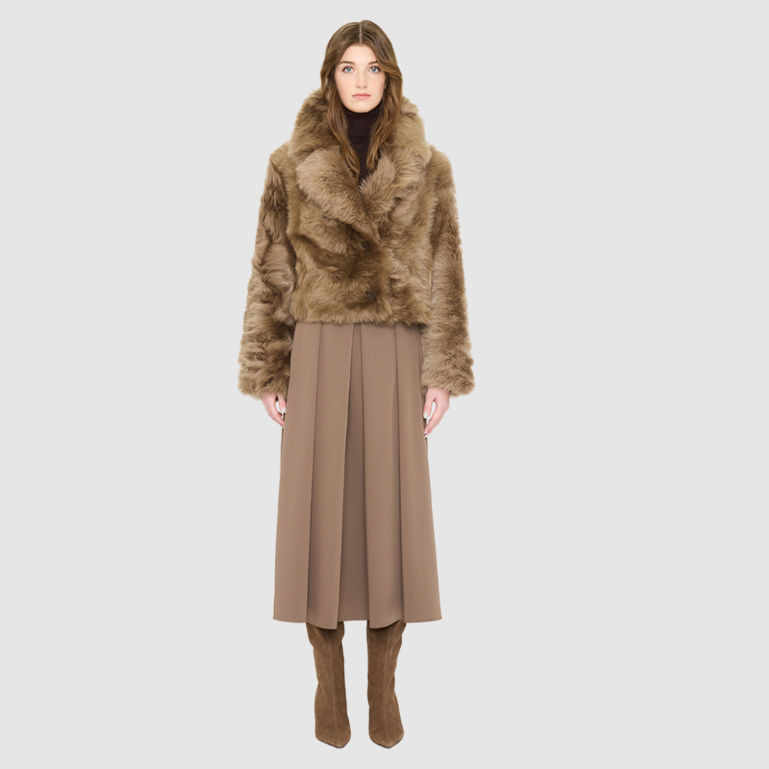 The NIKKI Bomber Jacket is a modern cropped silhouette crafted in luxurious toscana wool. Designed with a drop shoulder and a relaxed fit through the shoulders, arms, and body, it delivers effortless volume and an easy, natural drape. An oversized toscana notch collar and single-breasted button closure give it a clean, minimalist finish, while slash side pockets add everyday functionality. Fully lined for comfort, NIKKI is the ultimate statement jacket for sophisticated cold-weather layering.