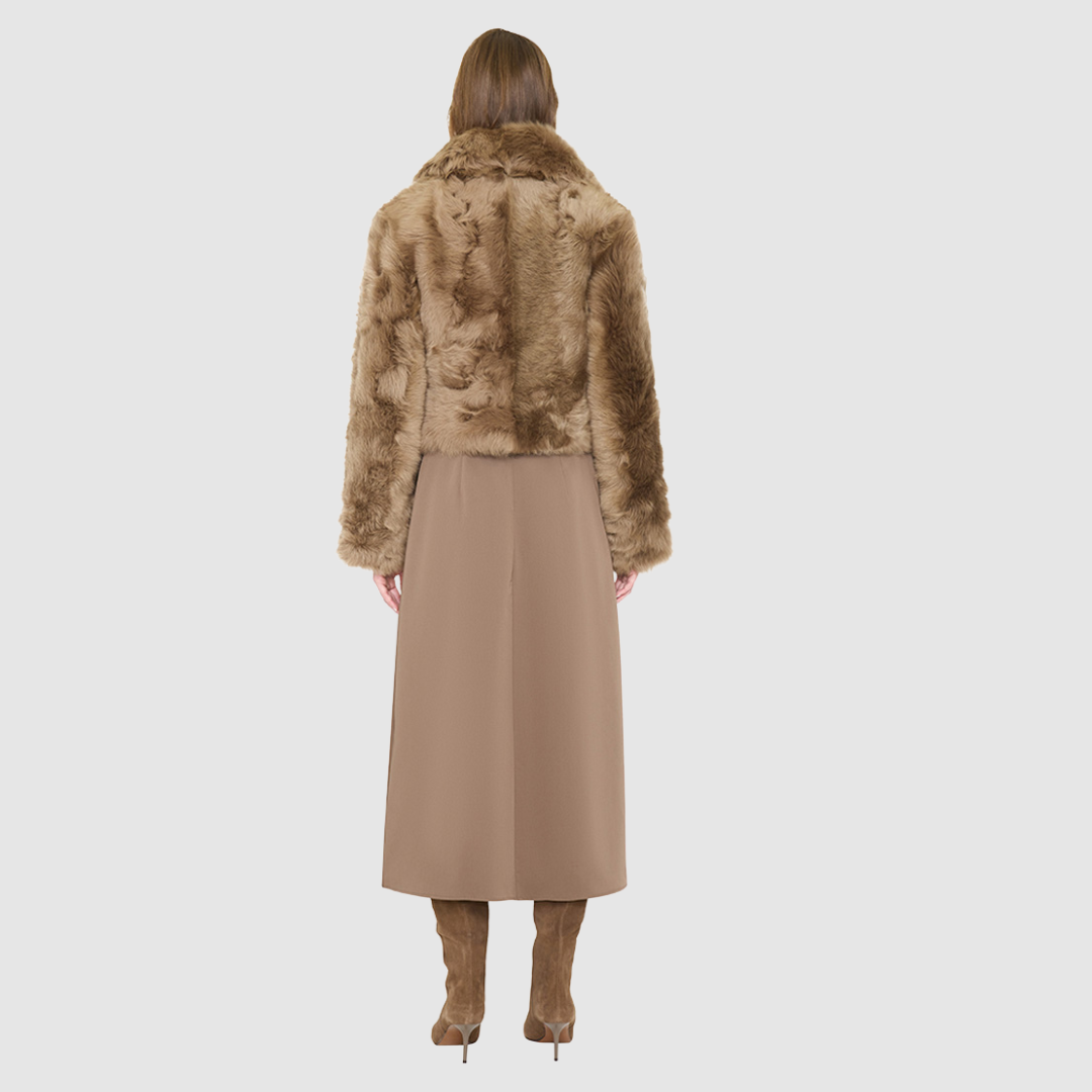 The NIKKI Bomber Jacket is a modern cropped silhouette crafted in luxurious toscana wool. Designed with a drop shoulder and a relaxed fit through the shoulders, arms, and body, it delivers effortless volume and an easy, natural drape. An oversized toscana notch collar and single-breasted button closure give it a clean, minimalist finish, while slash side pockets add everyday functionality. Fully lined for comfort, NIKKI is the ultimate statement jacket for sophisticated cold-weather layering.