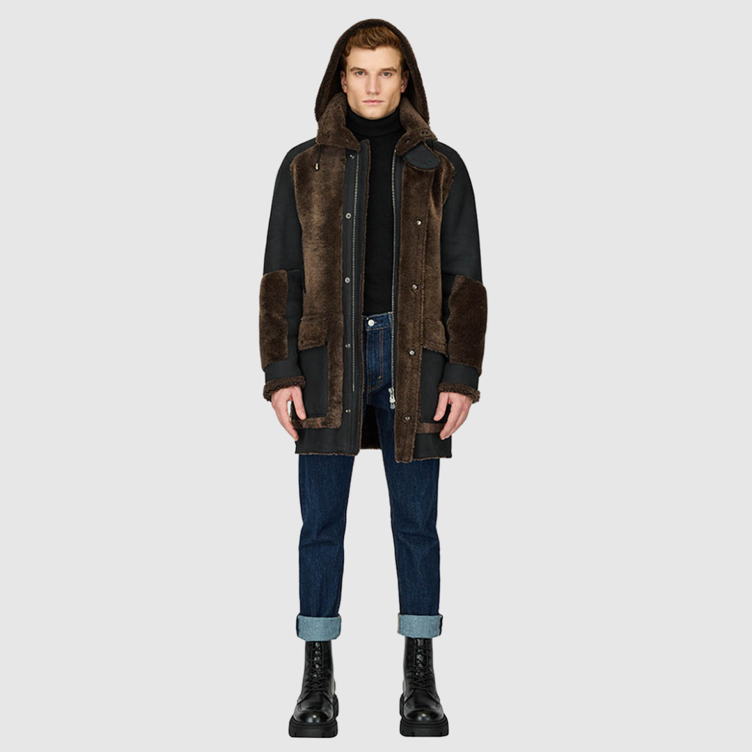 The Octavian Carbon Suede Shearling Parka is a modern mixed-media outerwear piece designed for versatility and functionality. Crafted with contrast curly wool exterior detailing and a removable hood, it features a slightly oversized fit with a regular shoulder for ease of movement. Oversized patch pockets and a front zip closure combine practicality with contemporary style, making it a cold-weather essential.