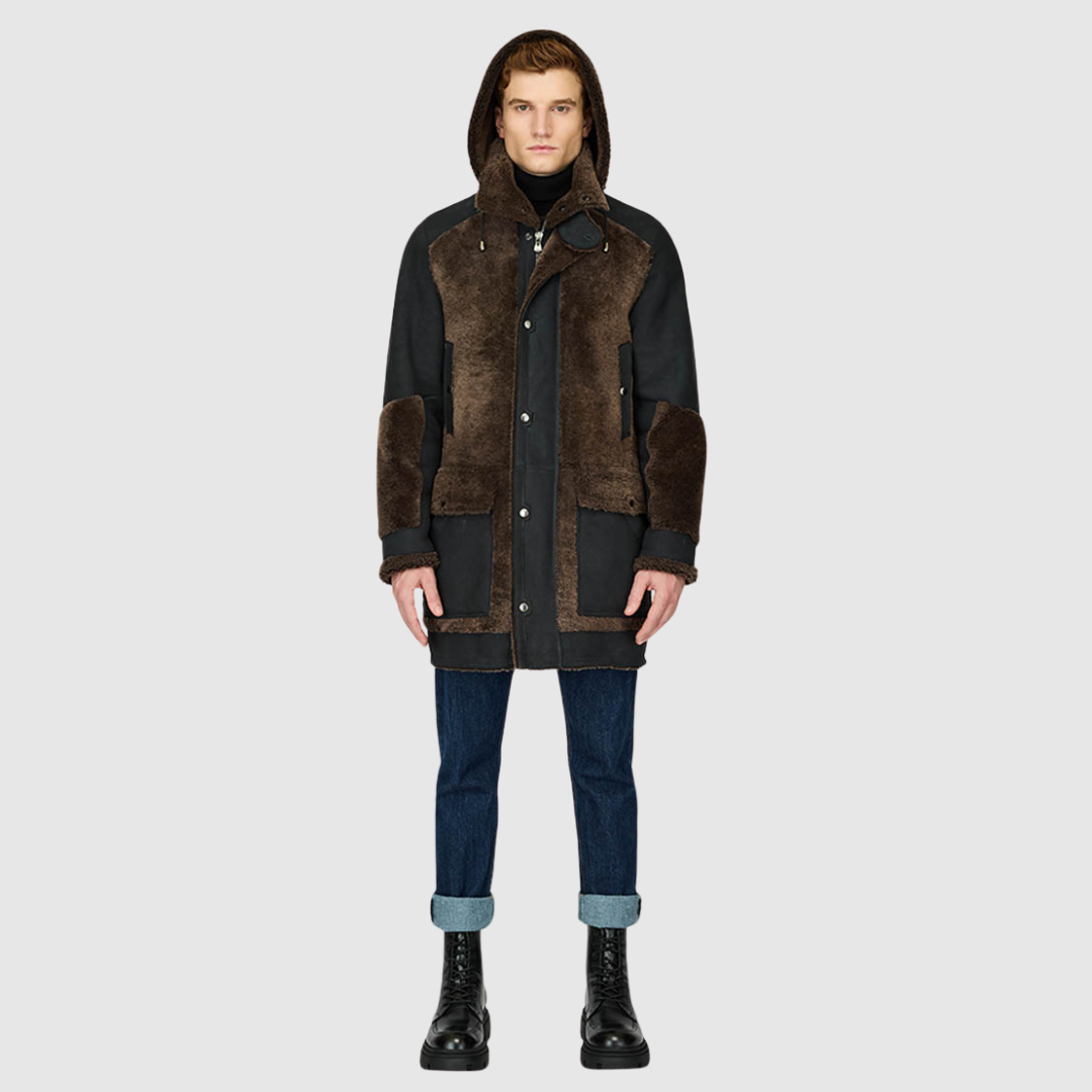 The Octavian Carbon Suede Shearling Parka is a modern mixed-media outerwear piece designed for versatility and functionality. Crafted with contrast curly wool exterior detailing and a removable hood, it features a slightly oversized fit with a regular shoulder for ease of movement. Oversized patch pockets and a front zip closure combine practicality with contemporary style, making it a cold-weather essential.