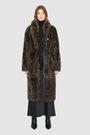 OMEGA introduces an element of understated luxury to cold-weather dressing, offering a longline silhouette engineered for seasonal transition. This exquisite investment outerwear piece pairs a deep carbon suede exterior skin with a rich, magnificent semi curly toscana wool teddy on the reverse side. Designed to shift seamlessly from a dramatic, texture-forward profile to a classic, minimalist skin-out aesthetic, this fully reversible coat adapts effortlessly to your outfit. 