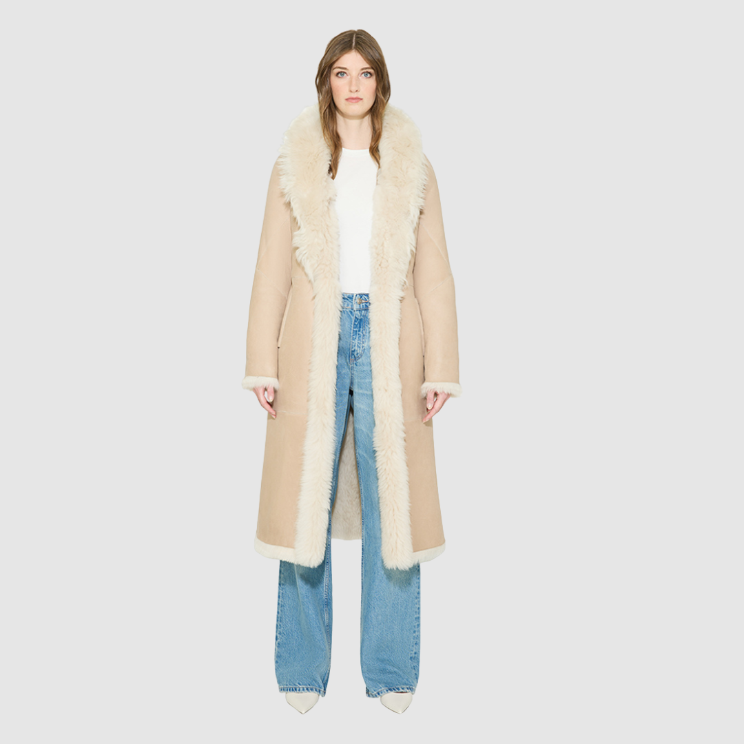 OMEGA introduces an element of understated luxury to cold-weather dressing, offering a longline silhouette engineered for seasonal transition. This exquisite investment outerwear piece pairs a suede exterior skin with a rich, magnificent semi curly toscana wool teddy on the reverse side. Designed to shift seamlessly from a dramatic, texture-forward profile to a classic, minimalist skin-out aesthetic, this fully reversible coat adapts effortlessly to your outfit. 