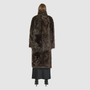 OMEGA introduces an element of understated luxury to cold-weather dressing, offering a longline silhouette engineered for seasonal transition. This exquisite investment outerwear piece pairs a deep carbon suede exterior skin with a rich, magnificent semi curly toscana wool teddy on the reverse side. Designed to shift seamlessly from a dramatic, texture-forward profile to a classic, minimalist skin-out aesthetic, this fully reversible coat adapts effortlessly to your outfit. 