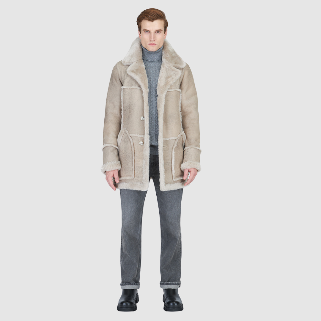 The Rebel stone vintage reversible shearling parka is a versatile mixed-media outerwear piece designed for modern utility and layered styling. Crafted with contrast iron wool exterior details, it features a slightly oversized fit with a regular shoulder for comfort. Oversized patch pockets and a button front closure provide practical functionality, while the reversible design allows two distinct styling options in one coat.