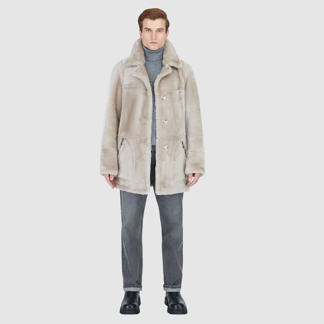 The Rebel stone vintage reversible shearling parka is a versatile mixed-media outerwear piece designed for modern utility and layered styling. Crafted with contrast iron wool exterior details, it features a slightly oversized fit with a regular shoulder for comfort. Oversized patch pockets and a button front closure provide practical functionality, while the reversible design allows two distinct styling options in one coat.