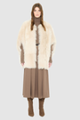 The ROTHEN Cocoon Vest is a modern oversized silhouette crafted in luxurious parchment-toned toscana wool. Designed with a generous drop shoulder and a relaxed, fluid drape, it delivers effortless volume and architectural style. A collarless neckline and discrete button closure give it a clean, minimalist finish, while a fully reversible design shifts from a suede side to a plush toscana teddy side for versatile styling. Providing ultimate natural insulation, ROTHEN is the ultimate statement piece for eleva