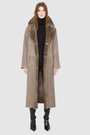 The SAVVY Coat is a modern full-length silhouette crafted in premium taupe badger shearling. Designed with regular shoulders and an easy, relaxed drape, it delivers sophisticated volume and architectural presence. A substantial notch collar and single-breasted button closure give it a clean, minimalist finish, while a fully reversible construction shifts from a refined suede side to a plush, iron wool side for versatile styling. Providing ultimate natural warmth, SAVVY serves as a definitive statement coat 