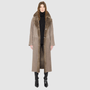 The SAVVY Coat is a modern full-length silhouette crafted in premium taupe badger shearling. Designed with regular shoulders and an easy, relaxed drape, it delivers sophisticated volume and architectural presence. A substantial notch collar and single-breasted button closure give it a clean, minimalist finish, while a fully reversible construction shifts from a refined suede side to a plush, iron wool side for versatile styling. Providing ultimate natural warmth, SAVVY serves as a definitive statement coat 