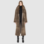 The SAVVY Coat is a modern full-length silhouette crafted in premium taupe badger shearling. Designed with regular shoulders and an easy, relaxed drape, it delivers sophisticated volume and architectural presence. A substantial notch collar and single-breasted button closure give it a clean, minimalist finish, while a fully reversible construction shifts from a refined suede side to a plush, iron wool side for versatile styling. Providing ultimate natural warmth, SAVVY serves as a definitive statement coat 