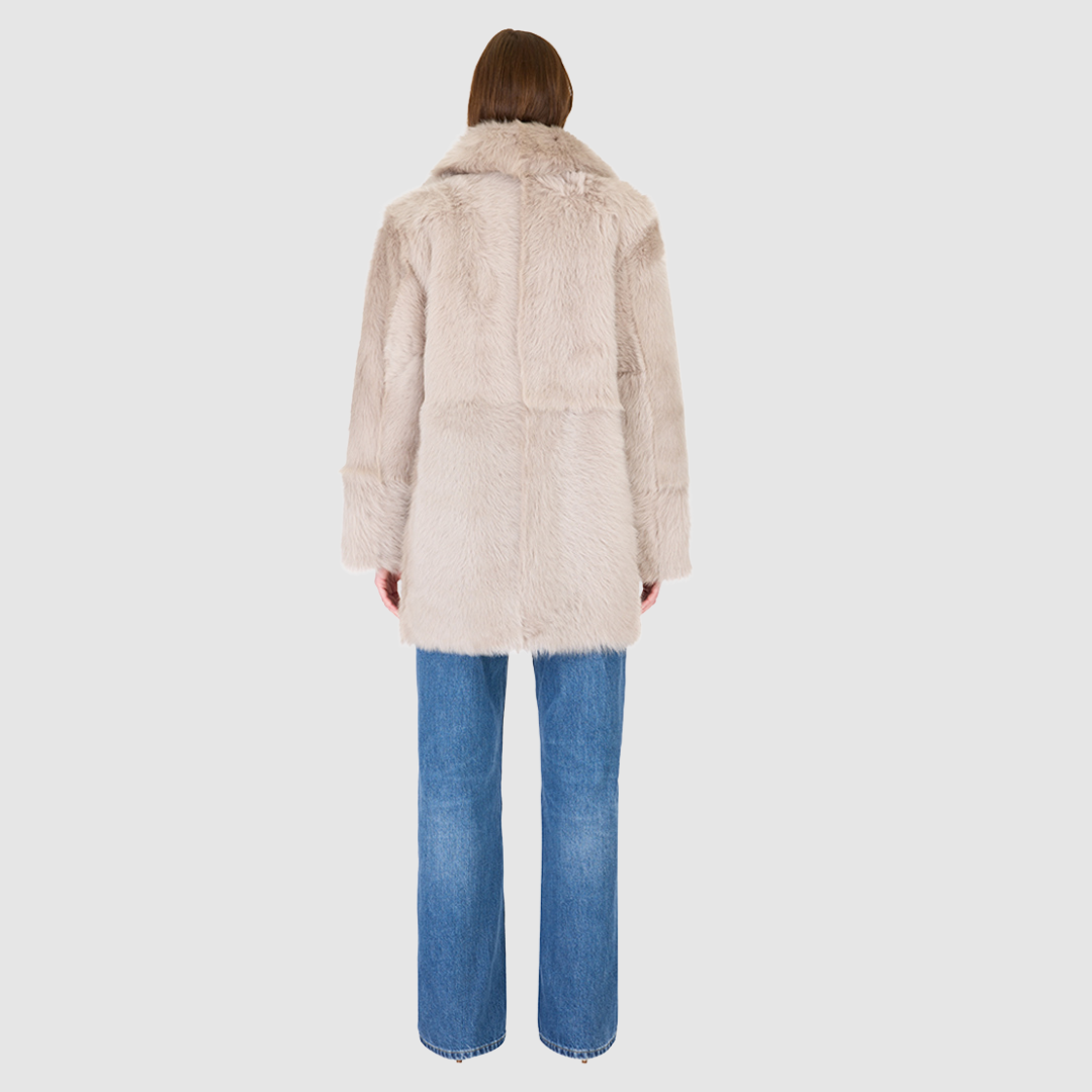 The SEER Jacket is a luxurious oversized outerwear piece crafted in Latte Toscana wool-out teddy. Designed with a structured shoulder and oversized Toscana notch collar, it delivers a bold, elevated silhouette. Fully lined for comfort, the jacket features slash side pockets for functionality and a single-breasted button closure for a polished finish. SEER combines plush texture with timeless tailoring for a standout cold-weather essential.