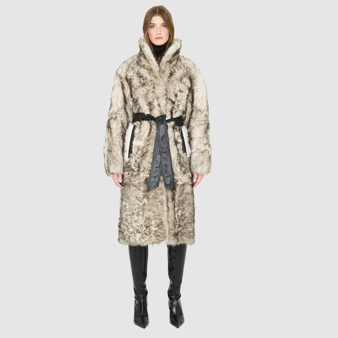 Model wearing the Magic Shadow Shearling Coat, a luxury winter shearling coat with a black leather tie belt.