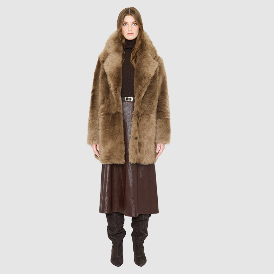The SIGNI Jacket is a modern oversized silhouette crafted in luxurious toscana wool. Designed with structured shoulders for a defined shape, it delivers effortless volume and architectural style. An oversized Toscana notch collar and single-breasted button closure give it a clean, minimalist finish, while slash side pockets add everyday functionality. Fully lined for comfort, SIGNI is the ultimate statement piece for cold-weather layering.