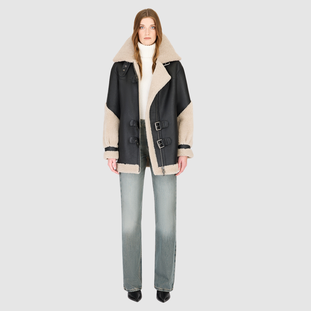 The VITAL Black Beige Nappa Curly Wool Jacket elevates contemporary moto design with a luxurious mixed-media finish. Crafted from smooth nappa leather and accented with plush curly wool on the collar, sleeves, and trims, it delivers a striking balance of structure and softness. The relaxed silhouette enhances comfort and layering, while signature moto elements—such as the spread collar with buckle detail and asymmetrical zip-and-buckle front closure—infuse the piece with modern edge.