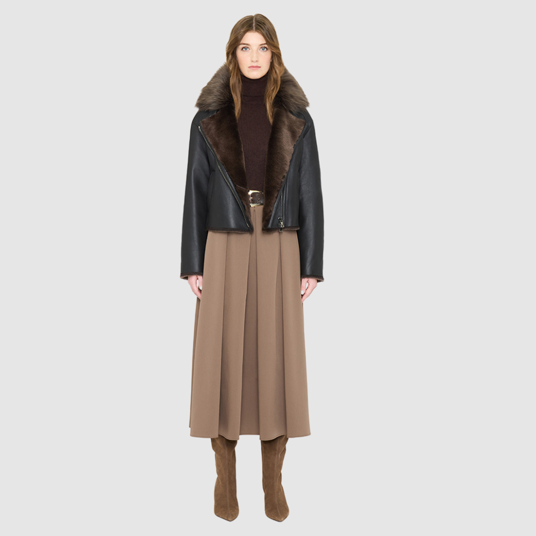 VRILL redefines alpine chic with a sharp, asymmetric profile tailored for effortless seasonal transitions. This cold-weather staple frames the body beautifully, pairing a refined matte nappa leather exterior with a uniform, plush ironed wool interior. Engineered for ultimate versatility across changing climates, the design transitions seamlessly from a classic skin-out moto jacket to a texture-forward statement piece complete with an exaggerated collar.