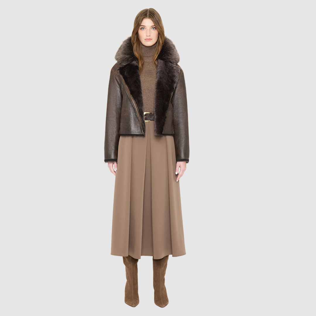 VRILL redefines alpine chic with a sharp, asymmetric profile tailored for effortless seasonal transitions. This cold-weather staple frames the body beautifully, pairing a refined matte nappa leather exterior with a uniform, plush ironed wool interior. Engineered for ultimate versatility across changing climates, the design transitions seamlessly from a classic skin-out moto jacket to a texture-forward statement piece complete with an exaggerated collar.