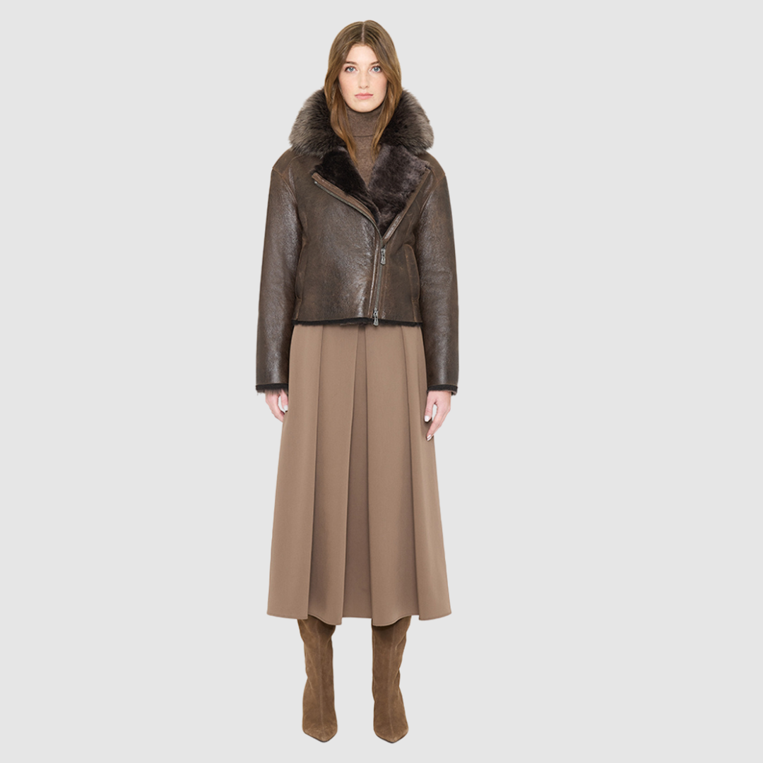 VRILL redefines alpine chic with a sharp, asymmetric profile tailored for effortless seasonal transitions. This cold-weather staple frames the body beautifully, pairing a refined matte nappa leather exterior with a uniform, plush ironed wool interior. Engineered for ultimate versatility across changing climates, the design transitions seamlessly from a classic skin-out moto jacket to a texture-forward statement piece complete with an exaggerated collar.