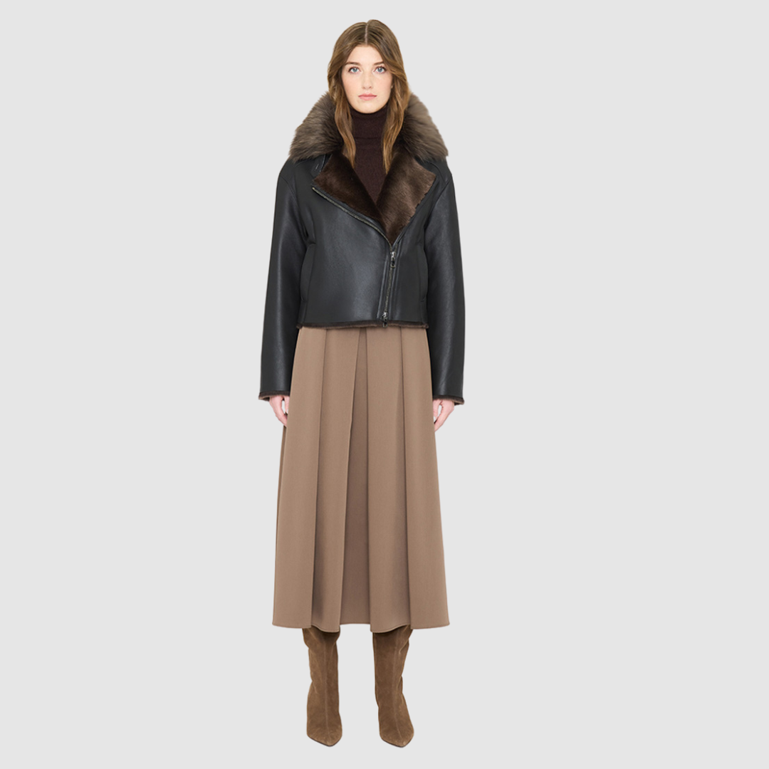 VRILL redefines alpine chic with a sharp, asymmetric profile tailored for effortless seasonal transitions. This cold-weather staple frames the body beautifully, pairing a refined matte nappa leather exterior with a uniform, plush ironed wool interior. Engineered for ultimate versatility across changing climates, the design transitions seamlessly from a classic skin-out moto jacket to a texture-forward statement piece complete with an exaggerated collar.