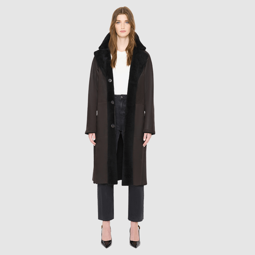 The ZIRA Coat is a heritage-inspired vintage reversible shearling jacket crafted in java nappa and iron wool. Designed to flip effortlessly from sleek nappa to plush iron wool teddy, it delivers versatile styling for both après-ski sophistication and everyday cold-weather elegance. Featuring a relaxed dropped shoulder, notch collar, and 3-button closure, ZIRA combines modern tailoring with timeless texture. Practical zip pockets on the nappa side and patch pockets on the teddy side