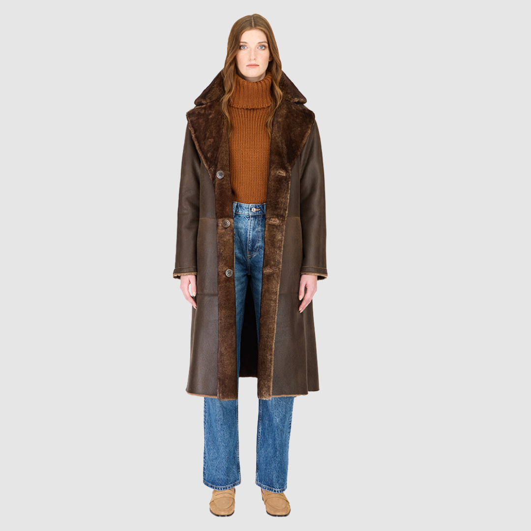 The ZIRA Coat is a heritage-inspired vintage reversible shearling jacket crafted in burma nappa and iron wool. Designed to flip effortlessly from sleek nappa to plush iron wool teddy, it delivers versatile styling for both après-ski sophistication and everyday cold-weather elegance. Featuring a relaxed dropped shoulder, notch collar, and 3-button closure, ZIRA combines modern tailoring with timeless texture. Practical zip pockets on the nappa side and patch pockets on the teddy side, along with tie belt