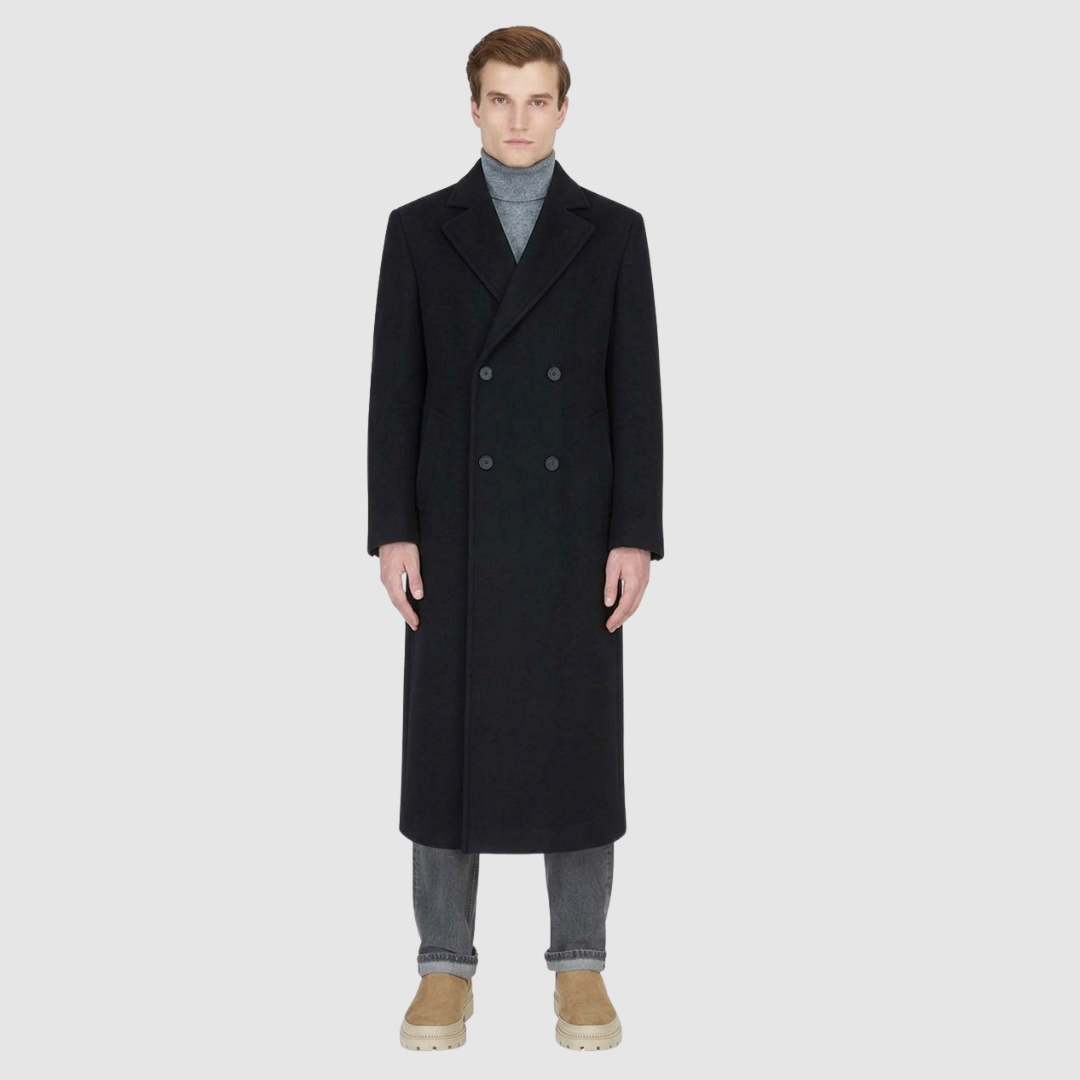 The ATLAS Coat is an elongated double-breasted silhouette crafted from a premium wool blend in an camel melange hue. Designed with structured shoulders and a tailored regular fit through the body, it delivers sharp architectural lines and a refined drape. A wide notch lapel and double-breasted button closure give it a clean, minimalist finish, while discrete side welt pockets and a single back vent add classic functionality. Fully lined for comfort, ATLAS serves as a  statement piece for cold-weather