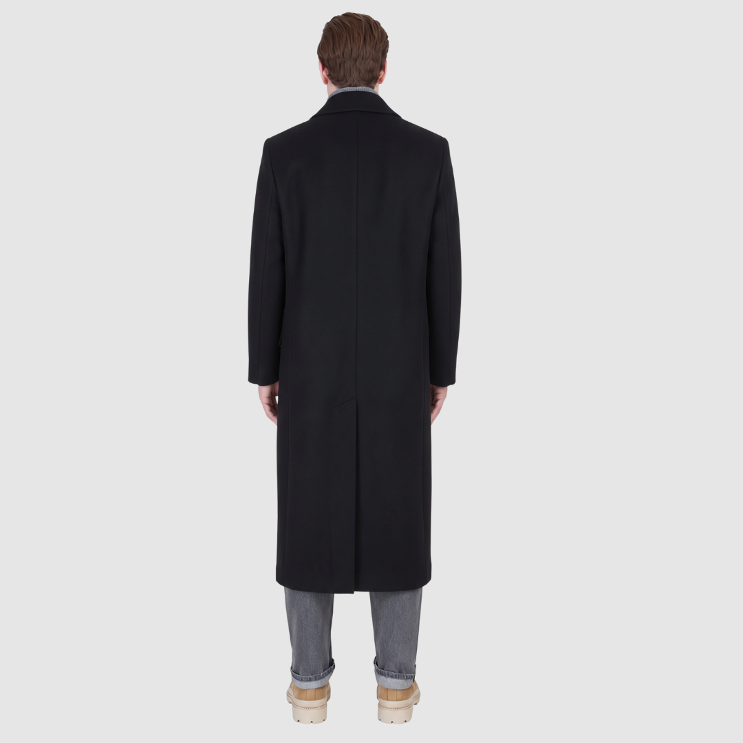 The ATLAS Coat is an elongated double-breasted silhouette crafted from a premium wool blend in an camel melange hue. Designed with structured shoulders and a tailored regular fit through the body, it delivers sharp architectural lines and a refined drape. A wide notch lapel and double-breasted button closure give it a clean, minimalist finish, while discrete side welt pockets and a single back vent add classic functionality. Fully lined for comfort, ATLAS serves as a  statement piece for cold-weather
