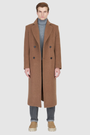 The ATLAS Coat is an elongated double-breasted silhouette crafted from a premium wool blend in an camel melange hue. Designed with structured shoulders and a tailored regular fit through the body, it delivers sharp architectural lines and a refined drape. A wide notch lapel and double-breasted button closure give it a clean, minimalist finish, while discrete side welt pockets and a single back vent add classic functionality. Fully lined for comfort, ATLAS serves as a  statement piece for cold-weather