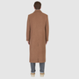 The ATLAS Coat is an elongated double-breasted silhouette crafted from a premium wool blend in an camel melange hue. Designed with structured shoulders and a tailored regular fit through the body, it delivers sharp architectural lines and a refined drape. A wide notch lapel and double-breasted button closure give it a clean, minimalist finish, while discrete side welt pockets and a single back vent add classic functionality. Fully lined for comfort, ATLAS serves as a  statement piece for cold-weather