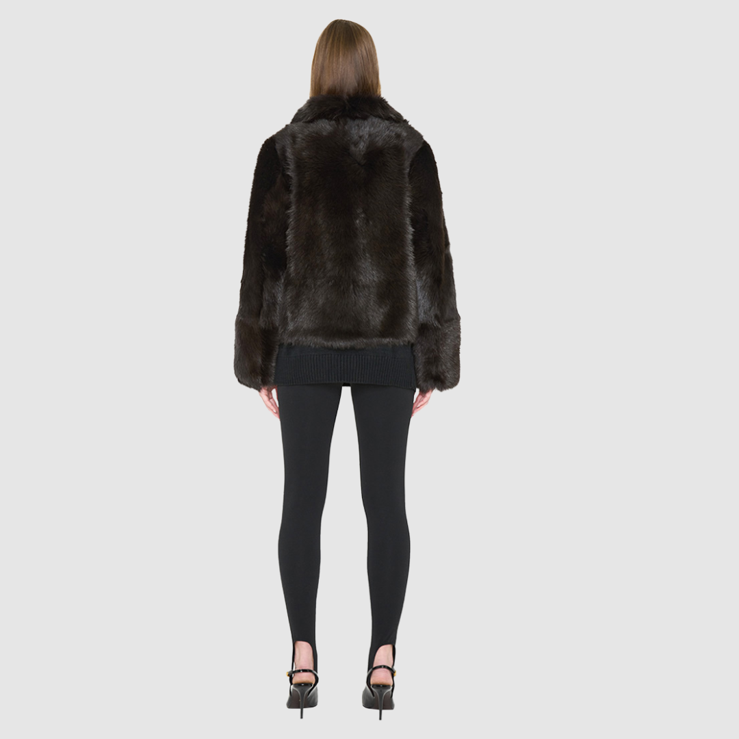 The HOPE Jacket is a versatile statement piece, crafted in chocolate toscana shearling with a modern cropped cut. Designed with a wool-out teddy finish, it reverses to a sleek nappa-out jacket, offering two looks in one. The relaxed shoulder and spread collar create a casual yet elevated silhouette, while slash side pockets add functionality. Finished with a front zip closure, HOPE is the perfect blend of cozy texture and polished edge.
