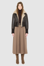 The CAVALLO delivers sharp alpine chic tailored for a metropolitan winter. This bomber jacket pairs rich brown matte nappa leather with a plush cream curly wool interior. Featuring integrated ribbed knit trim and a bold buckled collar, the cropped silhouette balances high-fashion utility with quiet luxury. Ideal for effortless layering, it moves easily from casual streetwear to an upscale cold-weather destination.