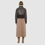 The CAVALLO delivers sharp alpine chic tailored for a metropolitan winter. This bomber jacket pairs rich brown matte nappa leather with a plush cream curly wool interior. Featuring integrated ribbed knit trim and a bold buckled collar, the cropped silhouette balances high-fashion utility with quiet luxury. Ideal for effortless layering, it moves easily from casual streetwear to an upscale cold-weather destination.