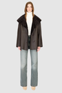 The CHEREZ Jacket is a modern mid-length hooded silhouette crafted in chocolate nappa leather shearling. Designed with drop shoulders, it offers dual-fit versatility with a tailored regular fit on the nappa side and a relaxed fit when reversed to the plush wool-out side. An exaggerated convertible hood drapes effortlessly across the shoulders as a shawl-like collar when unbuttoned, while a single-breasted button closure delivers a clean, minimalist finish. 