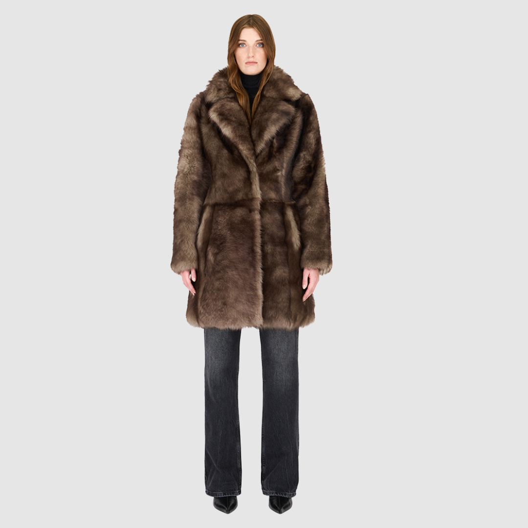 The CLOUD Jacket is a cozy, elevated outerwear essential crafted in Macassar Toscana wool-out mouton teddy. Designed with a regular shoulder and fitted torso, it provides a flattering silhouette while maintaining comfort across the shoulders. Functional slash side pockets and interior zip pockets keep essentials secure, while a front snap closure completes the clean, versatile design. CLOUD blends plush texture with modern tailoring for effortless cold weather style.