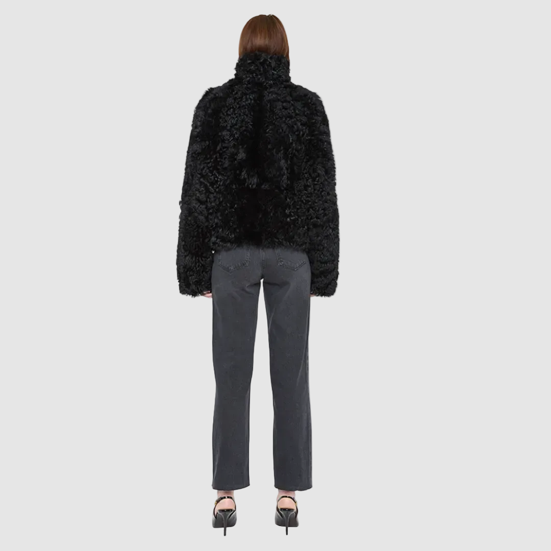 The HiSO CUPID Jacket is a heritage-inspired mid-length shearling jacket, masterfully crafted from premium semi-curly shearling wool for rich texture and dimension. Its regular shoulder and relaxed mid-length silhouette create a sleek, contemporary fit, while the dramatic, oversized stand collar offers an elevated, modern aesthetic. Designed with a versatile, reversible layout, this statement piece offers two distinctive looks in one