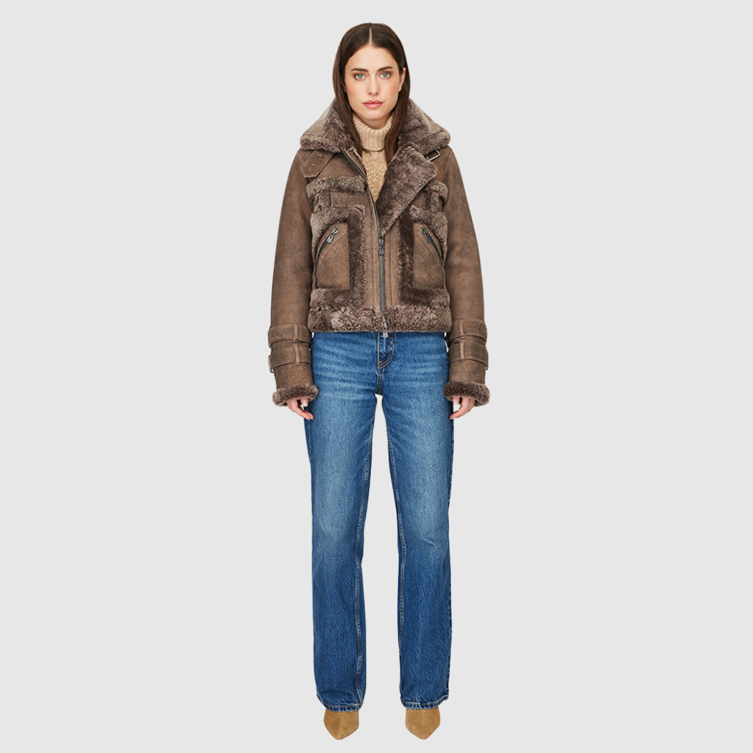 This cropped biker jacket is updated with contrasting wool seams. Crafted in genuine shearling, the jacket is finished with zip pockets and buckle accents at the collar and cuffs. Genuine Shearling Spread collar Long-sleeve Zipper closure Imported
