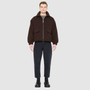 The MALCOLM Bomber Jacket is a modern silhouette crafted in a rich chocolate brown wool blend. Designed with drop shoulders and an easy, relaxed volume through the body, it delivers architectural presence and effortless style. A high convertible spread collar and two-way front zip closure give it a clean, minimalist finish, while oversized front flap patch pockets and elasticized cuffs and hem define the shape. Fully lined for comfort, MALCOLM serves as a definitive statement piece for cold-weather layering