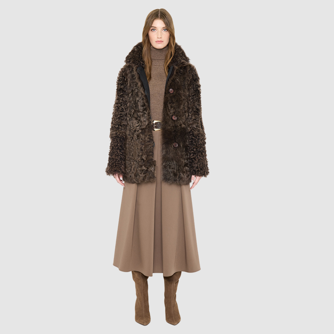 The HiSO MILKY WAY Jacket is a heritage-inspired mid-length shearling coat, masterfully crafted from premium Toscana shearling for unparalleled texture and depth. Its regular shoulder and relaxed mid-length silhouette create an elegant, contemporary fit, while the spread collar frames the face with plush, long-haired wool. Designed with a versatile, reversible construction, this statement coat provides two distinctive looks in one