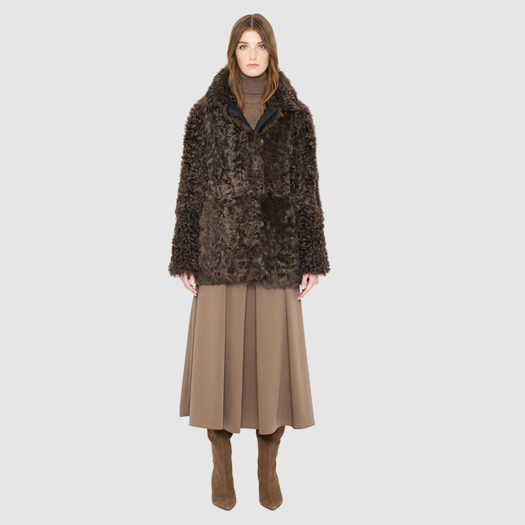 The HiSO MILKY WAY Jacket is a heritage-inspired mid-length shearling coat, masterfully crafted from premium Toscana shearling for unparalleled texture and depth. Its regular shoulder and relaxed mid-length silhouette create an elegant, contemporary fit, while the spread collar frames the face with plush, long-haired wool. Designed with a versatile, reversible construction, this statement coat provides two distinctive looks in one
