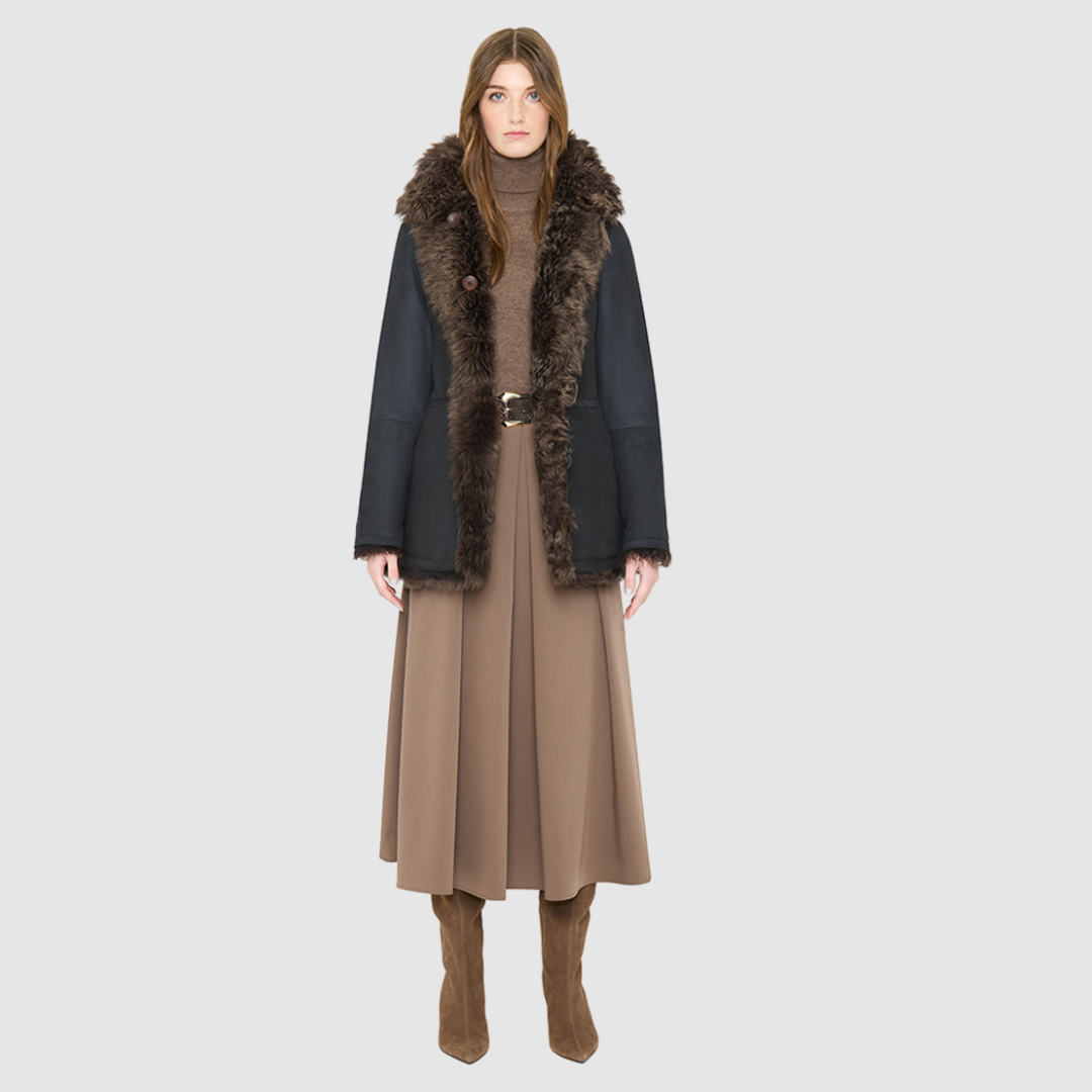 The HiSO MILKY WAY Jacket is a heritage-inspired mid-length shearling coat, masterfully crafted from premium Toscana shearling for unparalleled texture and depth. Its regular shoulder and relaxed mid-length silhouette create an elegant, contemporary fit, while the spread collar frames the face with plush, long-haired wool. Designed with a versatile, reversible construction, this statement coat provides two distinctive looks in one