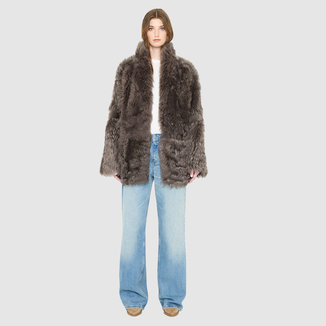 The HiSO MILKY WAY Jacket is a heritage-inspired mid-length shearling coat, masterfully crafted from premium Toscana shearling for unparalleled texture and depth. Its regular shoulder and relaxed mid-length silhouette create an elegant, contemporary fit, while the spread collar frames the face with plush, long-haired wool. Designed with a versatile, reversible construction, this statement coat provides two distinctive looks in one