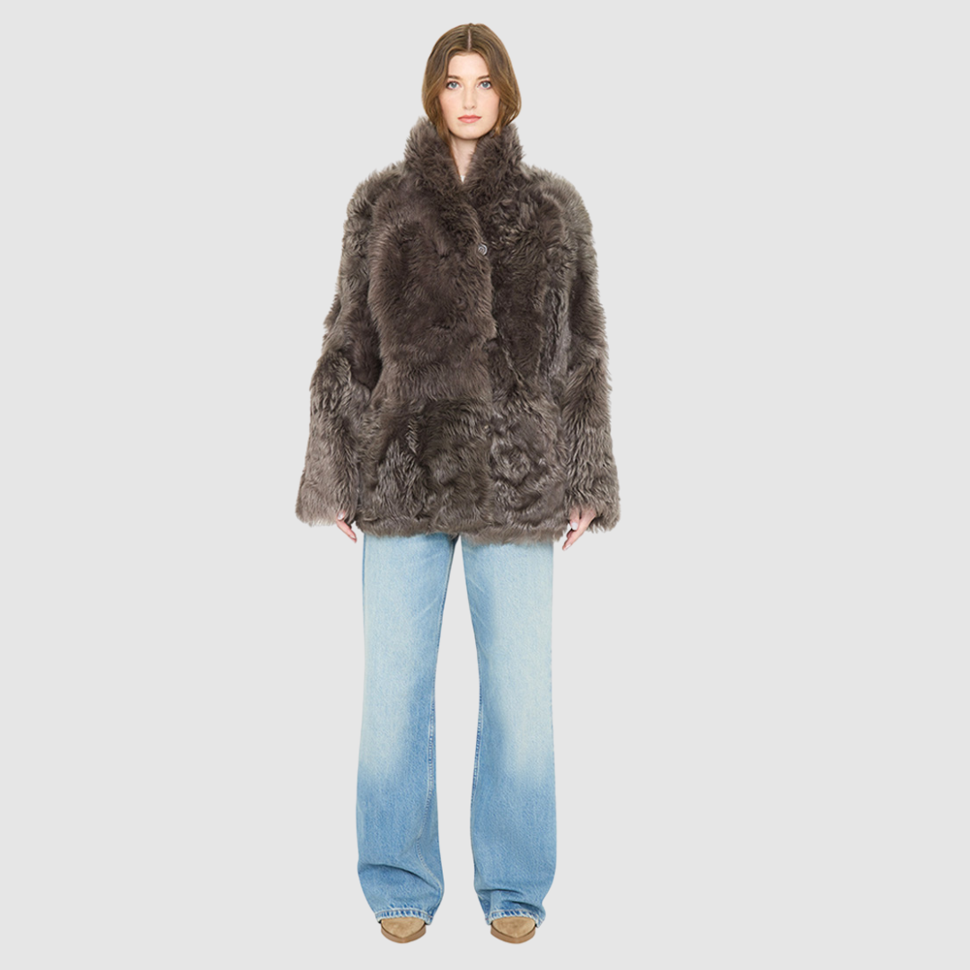 The HiSO MILKY WAY Jacket is a heritage-inspired mid-length shearling coat, masterfully crafted from premium Toscana shearling for unparalleled texture and depth. Its regular shoulder and relaxed mid-length silhouette create an elegant, contemporary fit, while the spread collar frames the face with plush, long-haired wool. Designed with a versatile, reversible construction, this statement coat provides two distinctive looks in one