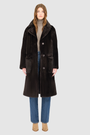 The PRADO Coat is a luxury vintage-inspired wool teddy coat crafted from chocolate ironed wool for a textured, modern finish. Designed with a relaxed dropped shoulder and tie belt at the waist, it combines effortless comfort with a flattering, cinched silhouette. A notch collar, large side patch pockets, and front button closure complete this statement wool teddy coat, perfect for elevated cold-weather styling.