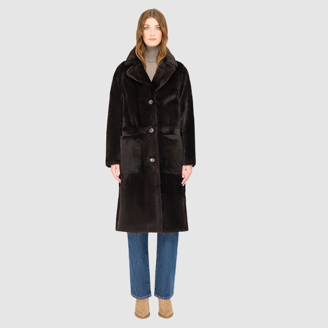 The PRADO Coat is a luxury vintage-inspired wool teddy coat crafted from chocolate ironed wool for a textured, modern finish. Designed with a relaxed dropped shoulder and tie belt at the waist, it combines effortless comfort with a flattering, cinched silhouette. A notch collar, large side patch pockets, and front button closure complete this statement wool teddy coat, perfect for elevated cold-weather styling.