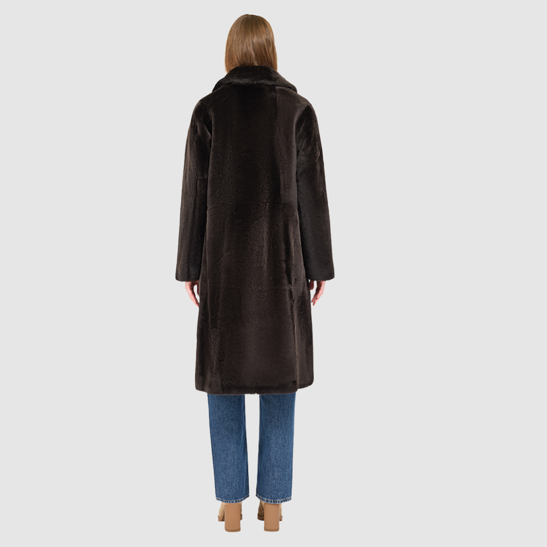 The PRADO Coat is a luxury vintage-inspired wool teddy coat crafted from chocolate ironed wool for a textured, modern finish. Designed with a relaxed dropped shoulder and tie belt at the waist, it combines effortless comfort with a flattering, cinched silhouette. A notch collar, large side patch pockets, and front button closure complete this statement wool teddy coat, perfect for elevated cold-weather styling.