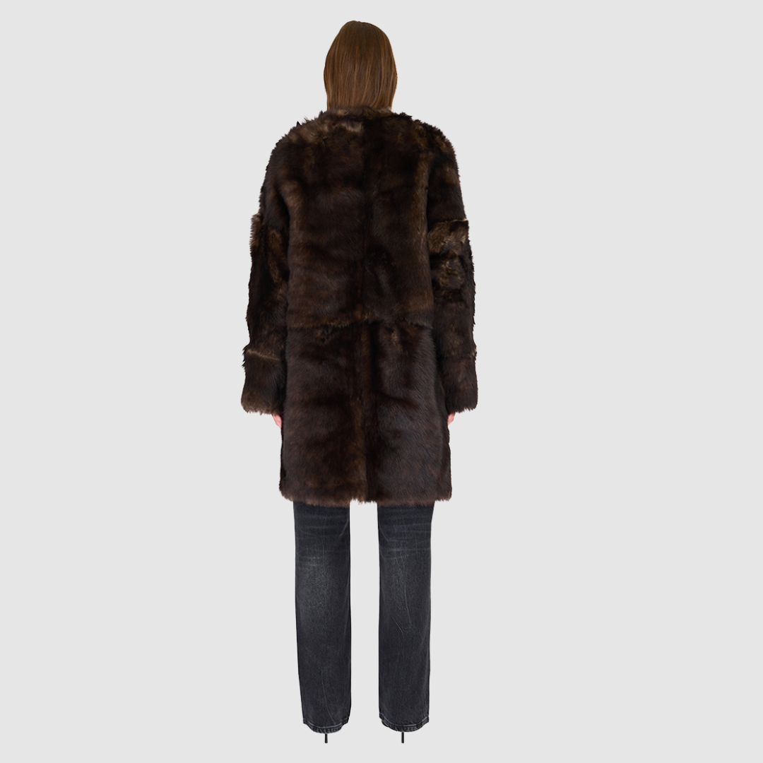 The ALLORA Jacket is a luxury reversible shearling teddy crafted in wolf Toscana for a rich and modern finish. Designed as a collarless oversized silhouette, it effortlessly flips from plush wool-out shearling to a sleek nappa skin-out jacket, offering two looks in one. With its generous fit through the shoulders, arms, and torso, ALLORA balances comfort and style. Functional slash side pockets on both sides and a front snap closure complete this elevated women’s reversible shearling jacket.