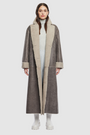 The DANIELLE Duster is a statement in heritage-inspired luxury and modern versatility. Crafted in Macassar nappa leather and plush curly wool shearling, this reversible oversized coat transitions effortlessly from sleek leather to cozy teddy texture. Its elongated silhouette is enhanced with a slight drop shoulder, back vent, and double-breasted button closure, creating timeless elegance with functional edge. Practical single welt pockets on the nappa side and slash pockets on the wool side