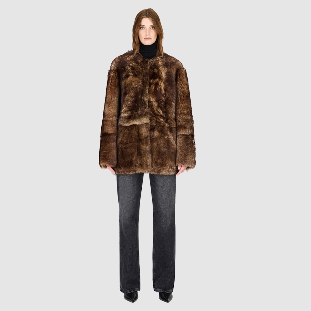 The Illumi Burma Nappa Toscana Jacket redefines modern luxury with its reversible, collarless design. Crafted from supple nappa leather and plush Toscana shearling, this oversized teddy-inspired silhouette offers two distinct looks in one. The wool-out side showcases rich texture and warmth, while the smooth nappa side delivers a sleek, refined finish. Designed for versatility and comfort, it features patch pockets on both sides and a clean snap-front closure—perfect for transitioning from city dressing to 