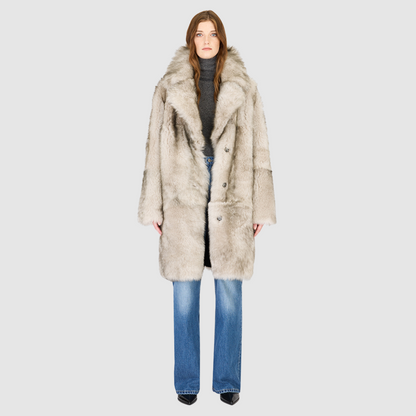 The JOY Jacket is a heritage-inspired reversible outerwear piece crafted in yingyang Toscana shearling. Designed to flip seamlessly from plush oversized teddy to sleek suede, it offers versatile styling for both après-ski sophistication and everyday winter elegance. With a drop shoulder, large notch collar, and oversized silhouette, JOY combines comfort with modern edge. Functional slash side pockets on the teddy side and single welt pockets on the nappa side, along with a front button closure.
