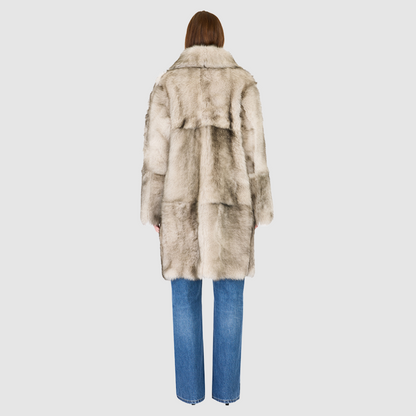 The JOY Jacket is a heritage-inspired reversible outerwear piece crafted in yingyang Toscana shearling. Designed to flip seamlessly from plush oversized teddy to sleek suede, it offers versatile styling for both après-ski sophistication and everyday winter elegance. With a drop shoulder, large notch collar, and oversized silhouette, JOY combines comfort with modern edge. Functional slash side pockets on the teddy side and single welt pockets on the nappa side, along with a front button closure.